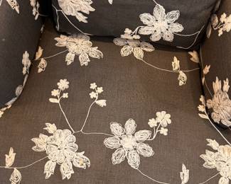 A close-up view of the floral fabric on the two matching upholstered chairs