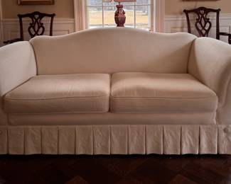 Camelback Sofa Upholstered in Cotton/Linen Blend with Pleated Skirt & Button Detail. Measures 84" W X 34" D. Photo 1 of 4. 
