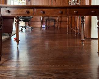 Three Drawer Mahogany Writing Desk on Casters.  Measures 60" W x 34" D x 31" H with 26" Clearance. Photo 1 of 6.