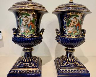 Pair of cobalt blue with gilt porcelain urns, hand painted with classical figures