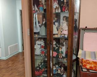 Nice Curio cabinet full of vintage and antique dolls and collectibles  
