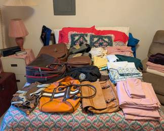 duffel bags, linens, queen size bed