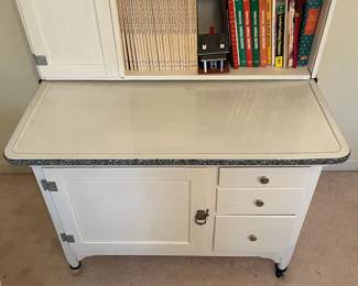 C58 - $300. Sellers Hoosier. Has been painted white. Enamel top is in good condition - some chipping that is normal for it's age. Measures 40.5" wide x 27.5" deep x 69" tall.  We have a couple bags of original hardware / tags that were taken off when it was painted. 