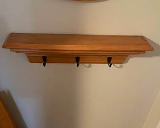 C41 - $25. Small Wooden Wall Shelf with hooks. Measures 23.5" wide x 4.5" deep x 6" tall. 