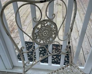 C76 - $40. Vintage Style White Wrought Iron Bistro Set that folds. Includes a round table and two matching chairs. Table is 24" x 26.25" tall. Chairs are 15.5" wide x 14" deep x 34" tall. Floor to seat is 17.25" Tall. 