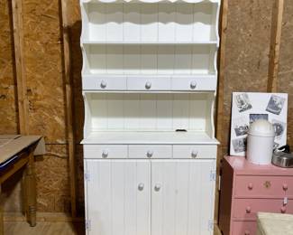 C84 - $40. Vintage White Hutch. Moves in 2 pieces for easier transport. Castors attached. Top is 36" wide x 9.5" deep x 38" tall. Base is 37" wide x 15" deep x 33" tall. 