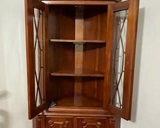 C95 - $225. Solid Wood Corner Cabinet - Moves in 2 Pieces. Measures 24" out from each corner and  39" across the front. 76" tall. Moves in 2 Pieces. 