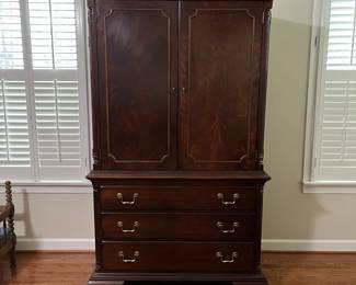 C98 - $250. Lexington Brand. Solid Wood. Flamed wood doors. Measures 46" wide x 25" deep x 76" tall. Also has another shelf if you don't have a TV in the cabinet. Moves in 2 pieces!