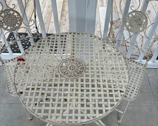 C76 - $40. Vintage Style White Wrought Iron Bistro Set that folds. Includes a round table and two matching chairs. Table is 24" x 26.25" tall. Chairs are 15.5" wide x 14" deep x 34" tall. Floor to seat is 17.25" Tall. 