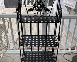 C70 - $40. 3 Tier Wrought Iron Folding Bakers Rack / Plant Stand. Measures 25" wide x 13.5" deep x 48" tall. 