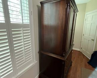 C98 - $250. Lexington Brand. Solid Wood. Flamed wood doors. Measures 46" wide x 25" deep x 76" tall. Also has another shelf if you don't have a TV in the cabinet. Moves in 2 pieces!