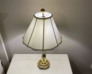 C149 - $30. Harvin Vintage Brass Lamp. Measures 24" tall. Shade has a small tear inside. 