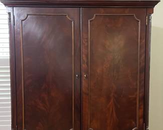 C98 - $250. Lexington Brand. Solid Wood. Flamed wood doors. Measures 46" wide x 25" deep x 76" tall. Also has another shelf if you don't have a TV in the cabinet. Moves in 2 pieces!