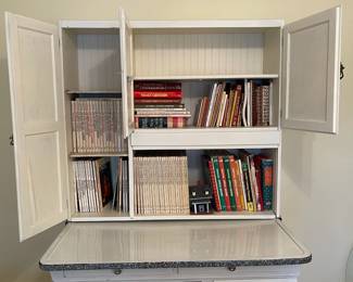 C58 - $300. Sellers Hoosier. Has been painted white. Enamel top is in good condition - some chipping that is normal for it's age. Measures 40.5" wide x 27.5" deep x 69" tall.  We have a couple bags of original hardware / tags that were taken off when it was painted. 