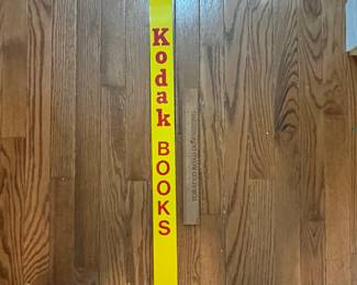 C143 - $40. Metal Kodak Books Sign. 