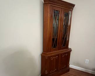 C95 - $225. Solid Wood Corner Cabinet - Moves in 2 Pieces. Measures 24" out from each corner and  39" across the front. 76" tall. Moves in 2 Pieces. 