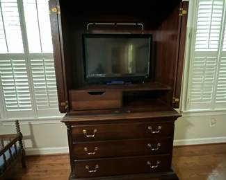 C98 - $250. Lexington Brand. Solid Wood. Flamed wood doors. Measures 46" wide x 25" deep x 76" tall. Also has another shelf if you don't have a TV in the cabinet. Moves in 2 pieces!