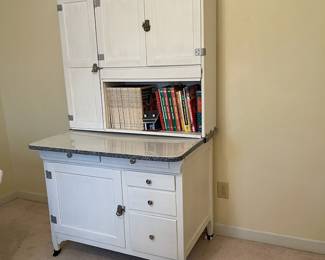 C58 - $300. Sellers Hoosier. Has been painted white. Enamel top is in good condition - some chipping that is normal for it's age. Measures 40.5" wide x 27.5" deep x 69" tall.  We have a couple bags of original hardware / tags that were taken off when it was painted. 