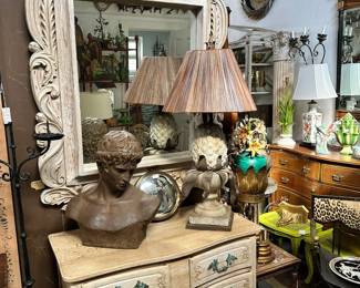 Large foliate-carved pickled mirror, Bust of Apollo, Bleached wood commode with verdigris pulls, Large pineapple table lamp, and more