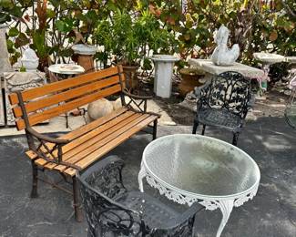 Garden bench, Round vintage aluminum cocktail table by Woodard, Pair of vintage aluminum foliate garden chairs by Woodard.