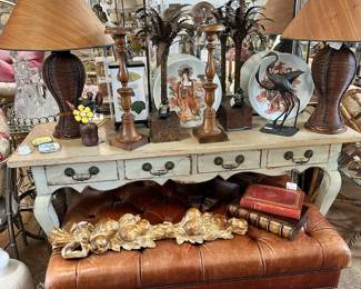 Large leather ottomon/coffee table, Narrow painted Italian console, Pair of pencil reed table lamps, Neoclassical style Venetian mirror, and more