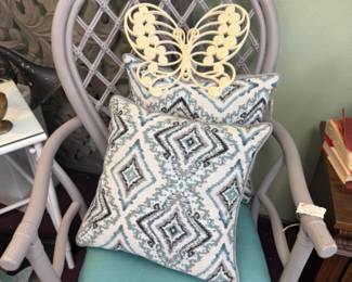arm chair, decorative pillows and butterfly wall hangings
