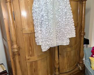 Curved door pine armore with decorative pillars (and beautiful beaded jacket)