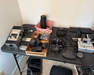 Two cameras plus extra lens, Kodak camera, and picture maker