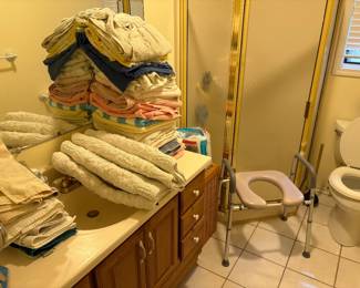 Bathroom towels, bath set, and a walker