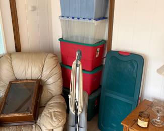 Vacuum cleaner, empty totes, worn recliner