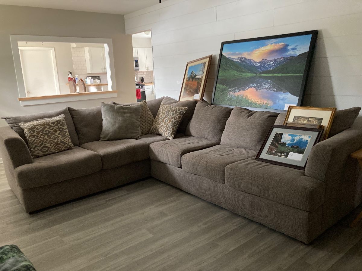 L-shaped sofa and framed art