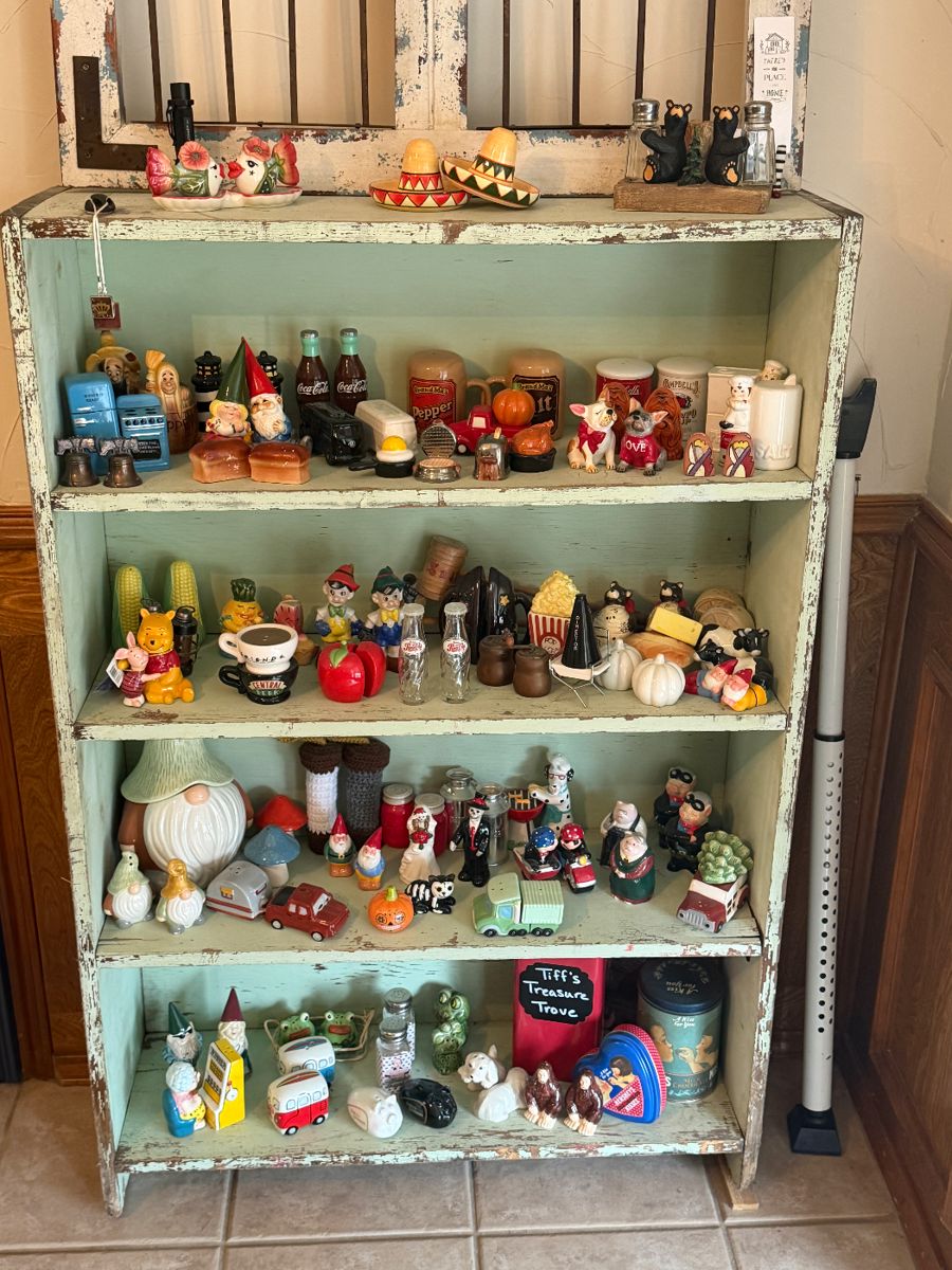 This unique collection of salt and pepper shakers is a must-see! The seagreen distressed shelf is also for sale.