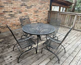 Wrought iron patio table with four chairs 