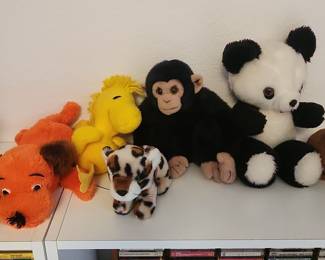 Assorted Plush Stuffed Animals including a dog, a yellow character, a chimpanzee, a leopard/cheetah, and a panda bear