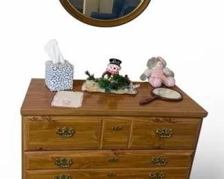 Vintage Wood Dresser with Round Wall Mirror and Decorative Accessories