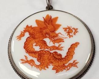 Meissen porcelain pendant with a red court dragon design set in silver bezel on silver chain