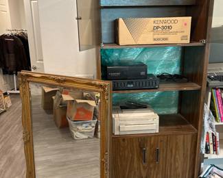 Bookshelf with cabinet, Kenwood DP – 3010 compact disc player, BLAUPUNKT compact this changer, Sansui stereographic equalizer SE – 1000, LaserJet 4L printer, French style, gold tone mirror.