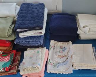 Lots of linens, bath and kitchen items - plenty of table clothes, placemats and napkins etc.