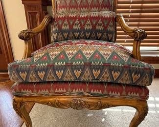 Antique Louis XV style carved upholstered armchair, circa early 20th century, will add a classic touch to any contemporary style. It is upholstered in a flame stitch fabric and has down filled cushion. The wood frame has carved details, the most prominent being a flower on the top of the chair, and then continues to the arms and legs. It's a unique and comfy accent chair for any living space. Great condition Measures 24" wide, 29" deep, 39” tall, 21" seat width, 24” seat depth, 19" seat height. $450