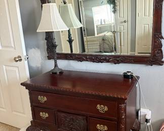 ornate dresser and wood framed mirror