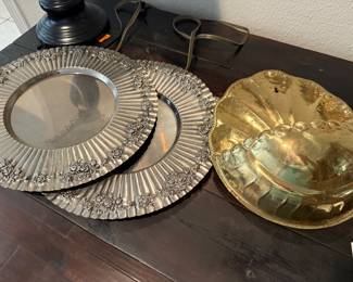 pewter charger plates and brass wall hanging