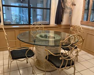 Dinette set with glass top table and metal chairs with cushion seats