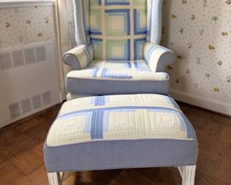 Vintage wingback chair and matching ottoman that have been custom-reupholstered using a quilted patchwork design