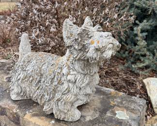 Concrete or cast stone garden statue of a terrier dog, specifically modeled after a Scottish Terrier (Scottie) or West Highland White Terrier (Westie)