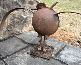 Folk art garden sculpture of a bird created from repurposed antique farm equipment parts.  Starline Inc. Harvard: This refers to the Starline Factory (originally Hunt, Helm, Ferris & Co.) based in Harvard, Illinois. Founded in 1883, the company was a major manufacturer of agricultural equipment, such as hay carriers, barn door hangers, and stalls.