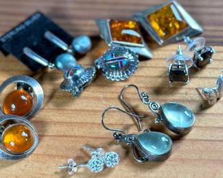 This lot features a curated collection of eight (8) pairs of sterling silver earrings with a total approx. weight of 32.21 grams.
