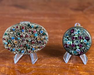 This lot features a pair of antique compacts manufactured by Dorset Fifth Avenue & Sweet Romance.