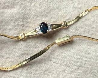 This lot features a stunning 14k gold bracelet with genuine diamonds and what appears to be a sapphire center stone. The bracelet measures, 7” and has a total approx. weight of 3.26 grams.