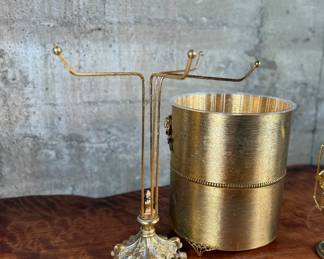 This lot features a curated collection of vintage Hollywood Regency-style bathroom accessories including a soap tray, a tissue holder, waste basket, and more.