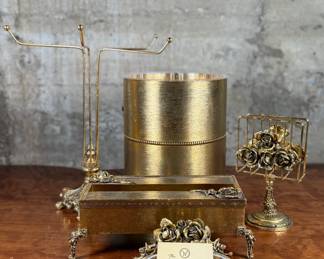 This lot features a curated collection of vintage Hollywood Regency-style bathroom accessories including a soap tray, a tissue holder, waste basket, and more.